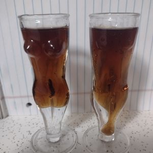 Pair of male and female naked torso shot glasses.